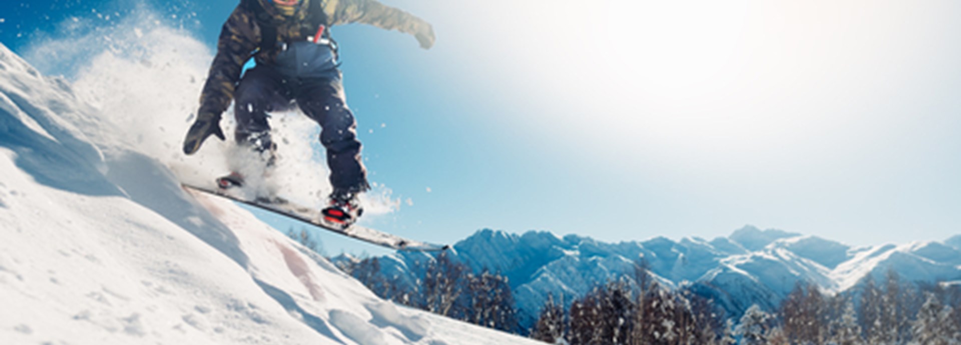 snowboarder is jumping with snowboard from snowhill on holidays